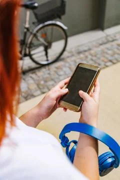 Woman's hands close up using mobile phone outdoor Stock Photos