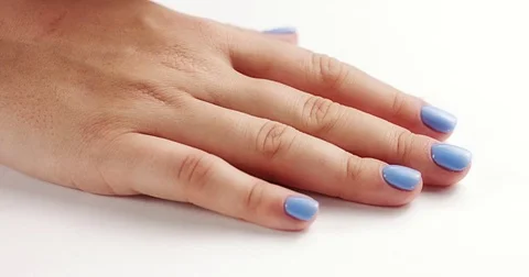 Woman's hands closeup isolated on light blue Stock Footage 80827053