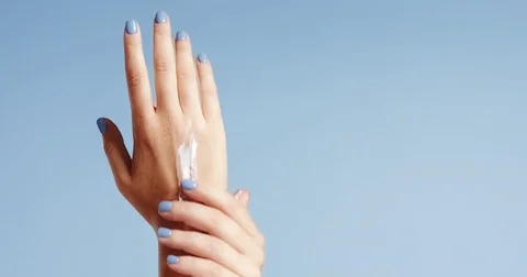 Woman's hands closeup isolated on light blue Stock Footage 80827147