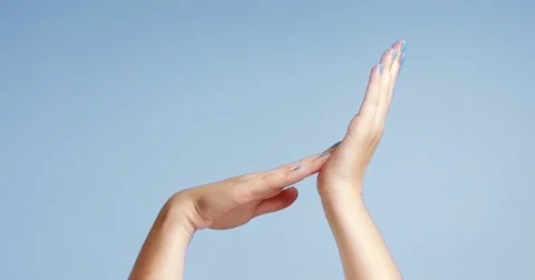 Woman's hands closeup isolated on light blue Stock Footage 80827304