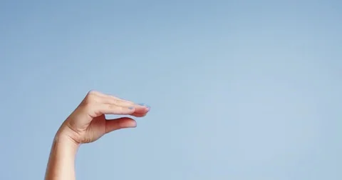 Woman's hands closeup isolated on light blue Stock Footage 80827312