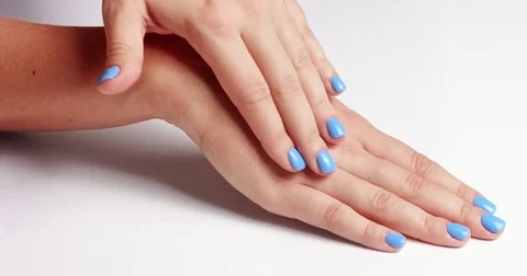Woman's hands closeup isolated on light blue Stock Footage 80827333