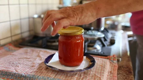 Womans hands closing jars with tomatoes preservation with a key for preservation Stock Footage 112132656