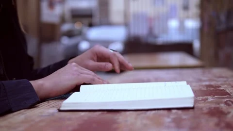Woman’s Hands Closing a Planner After Writing Something Important Stock Footage 320257036