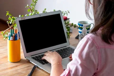 Woman's hands computer at home, with a computer during the coronavirus quaran Stock Photos
