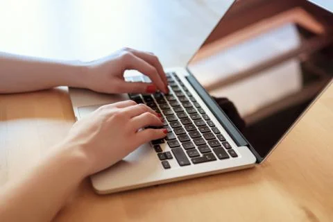 Woman's hands on a computer keyboard Stock Photos