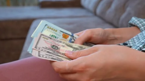 Woman's hands counting american dollar bills Video stock 329472304