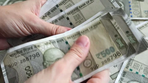 Woman's hands counting brand new indian 500 rupees banknotes. Stock Footage 277159580