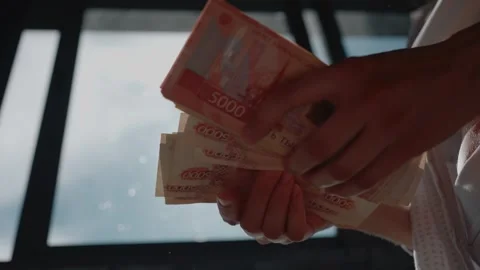 Woman's hands counting a large stack of russian ruble currency banknotes, close Stock Footage 344255382