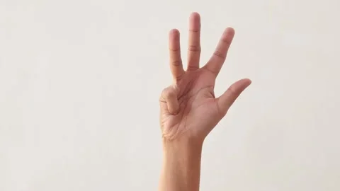 Woman's hands counting the numbers one to ten on a white background. Video stock 291856403