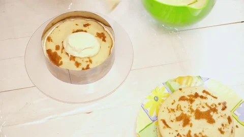 Woman's hands covering the cake with the cream Video stock 74472979