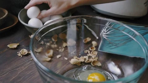 Woman's hands cracking an egg	 Stock Footage 75759522