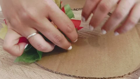 Woman's hands creating a DIY craft wreath with colorful tissue paper Stock Footage 341466105