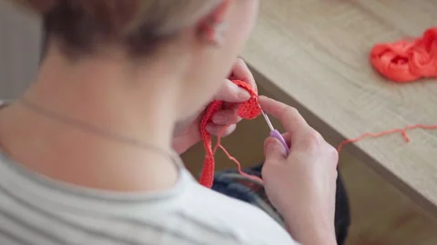 Woman's hands crocheting doll's clothes watching online course lessons. Craft an Vidéo 307635883