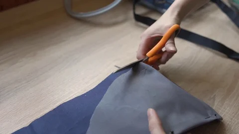 The woman's hands cut the fabric with scissors Video stock 128197905