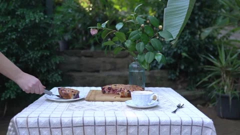 Woman's hands cut hot berry pie and put a piece on a table. Stock Footage 141017738