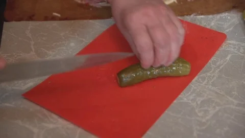 The woman's hands cut the marinated cucumber into slices. Stock Footage 74994084