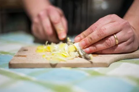 Woman's hands cut vegetables on chopping board Stock Photos