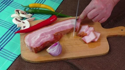 Woman's hands cutting bacon into strips Stock Footage 59325745