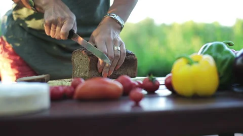 Woman's hands cutting bread with a knife 스톡 동영상 33913724
