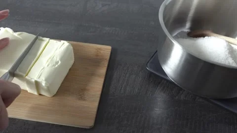 A woman's hands cutting butter into cubes. Stock Footage 341658817