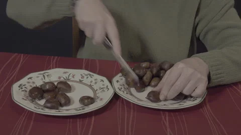 Woman's hands cutting chestnuts with knife Stock Footage 321751723