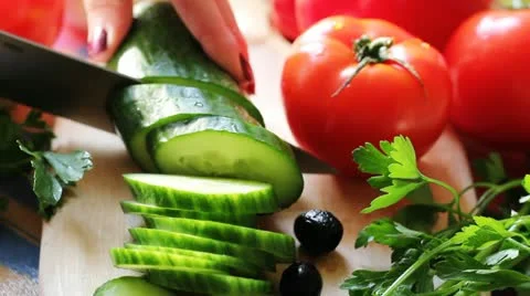 Woman's hands cutting cucumber Stock Footage 11225989