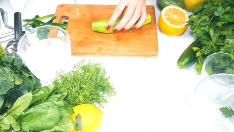 Woman's hands cutting cucumber Stock Footage 106476426