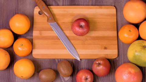 Woman's hands cutting fresh apple on kitchen Stock Footage 123356310