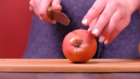 Woman's hands cutting fresh apple on kitchen Stock Footage 123465459