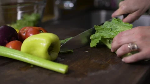 Woman's hands cutting lettuce Stock Footage 57238324
