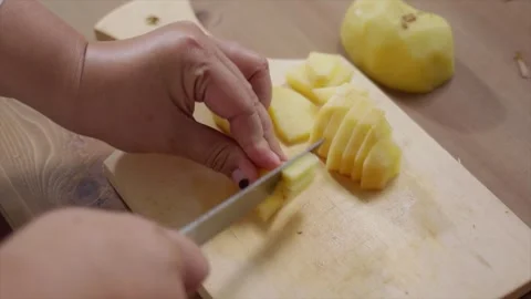Woman's hands cutting potatoes on a cutting board 스톡 동영상 329684895
