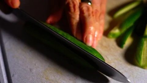 Woman's Hands Cutting Small Cucumbers in Slow Motion Closeup Stock Footage 125339093