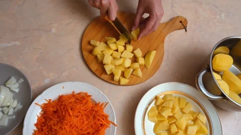 Woman's hands dicing raw potatoes for soup Stock Footage 328589608