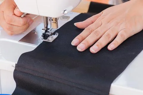 Woman's hands, doing her patchwork using sewing machine Stock Photos