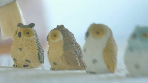 Womans hands dusting tiny ceramic owls with paint brush. Color corrected V. Stock Footage 72864012