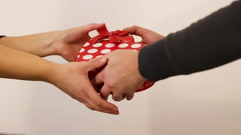 A woman's hands enter the frame and receive from a man,  Stock Footage 230937659