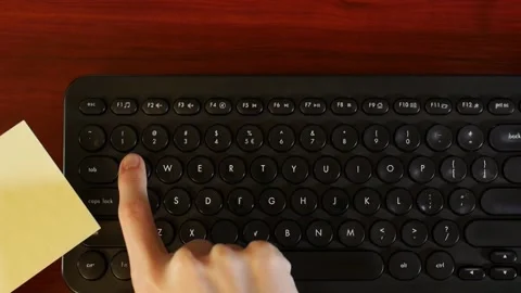 Woman's hands enter "qwerty" computer password, shot from above Stock Footage 152581577
