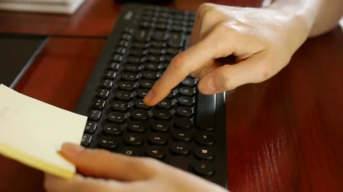 Woman's hands enter "qwerty" computer password, shot from aside Stock Footage 152581581
