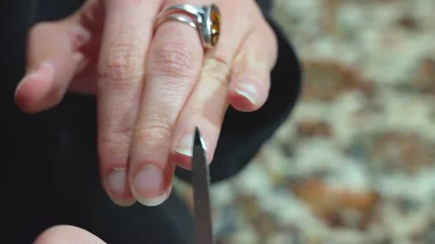 Woman's hands filing her nails on a carpet Video stock 307635188