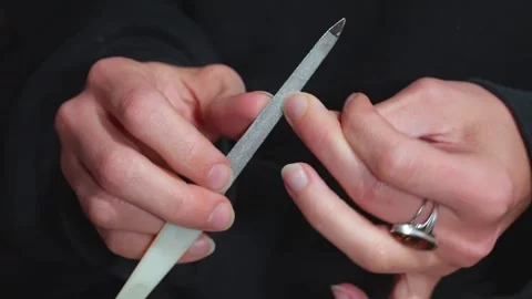 Woman's hands filing her nails Stock Footage 307635390
