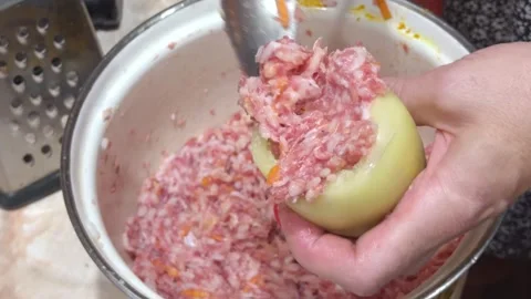 Woman's hands fill a bell pepper with minced meat and rice using a spoon fr.. Stock Footage 340644327