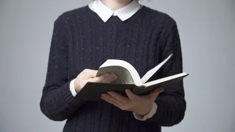 Woman's hands flipping  through a book Stock Footage 70614865