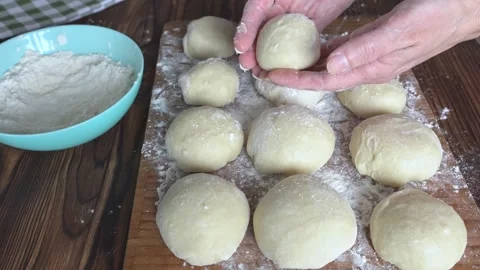 A woman's hands forming buns from dough. Close-up. Homemade baking. Stock Footage 335856486
