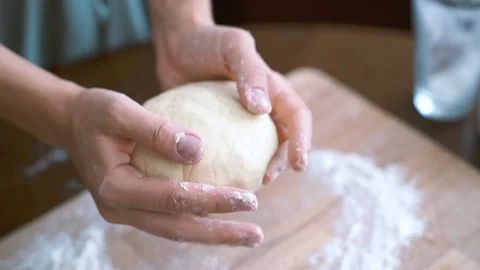 Woman's hands forming dough for bread Stock Footage