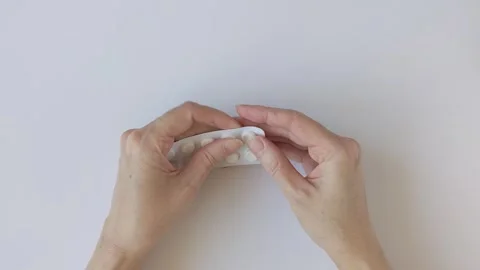 Woman's hands gently press on a blister pack of pills and pull one out Stock Footage 330748419