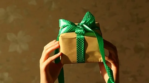 Woman's hands with gift box with green ribbon, holidays concept 스톡 동영상 83432530