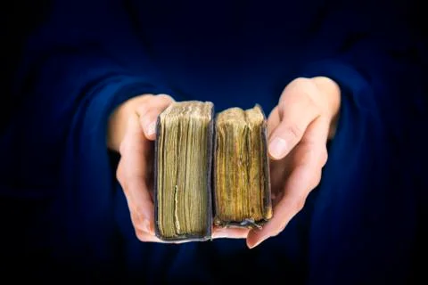 Woman's hands giving two old books Stock Photos