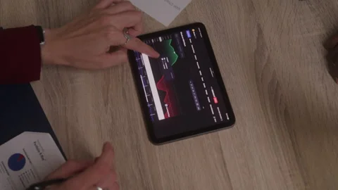 Womans Hands Going over Graphs on a Tablet and Taking Notes Video stock 218441676