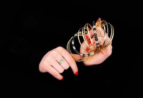 Woman's hands with golden bracelets Stock Photos